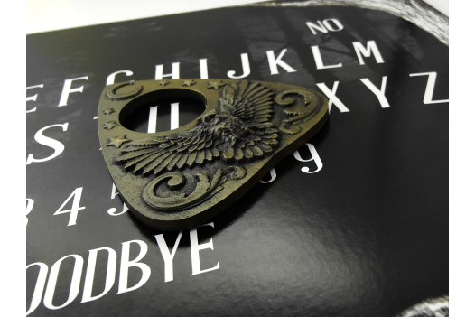 Eerie Owl Planchette on Ouija Board